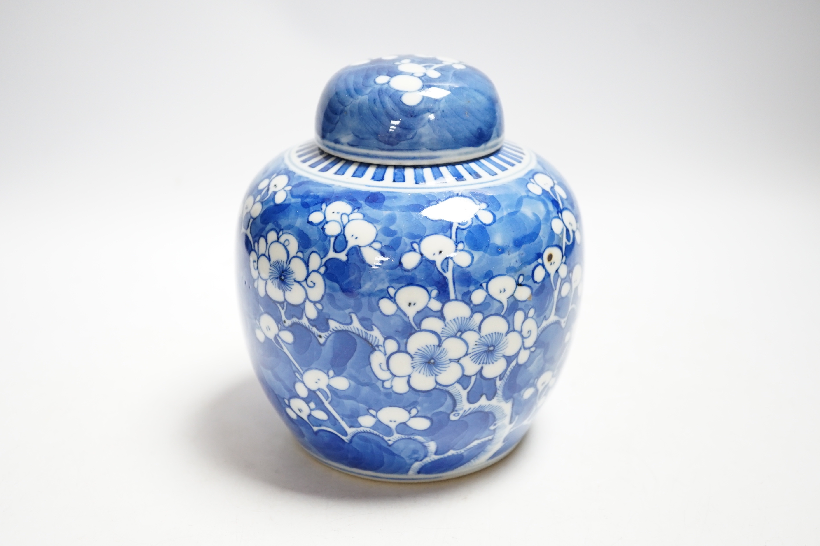 An early 20th century Chinese blue and white prunus jar and cover, 14cm